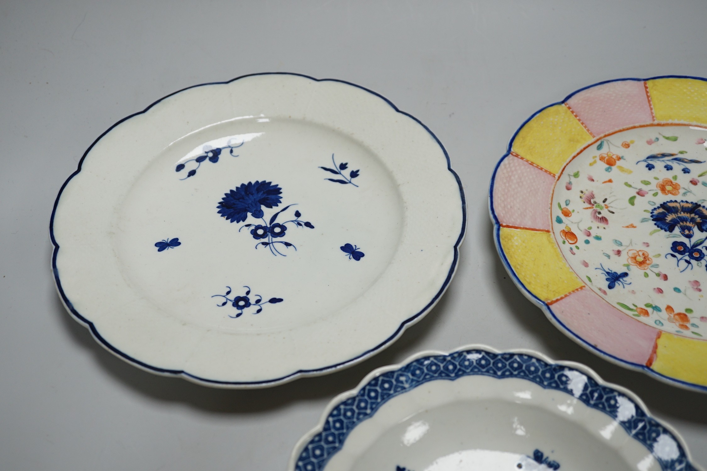 An 18th century Caughley plate printed with Gillyflower variation 5, 20.5cms diameter and two plates with the Carnation pattern, one with added polychrome decoration